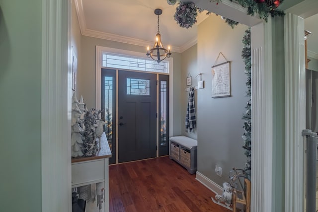 foyer with dark hardwood / wood-style floors, crown molding, and an inviting chandelier