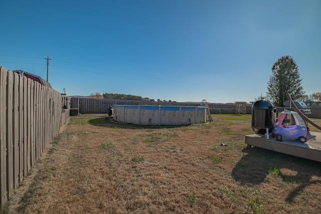 view of yard featuring a fenced in pool and a fenced backyard