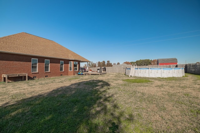 view of yard with a fenced in pool