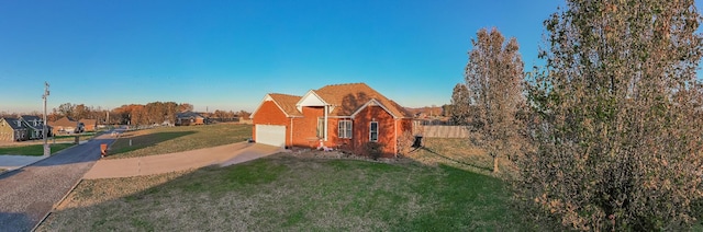 view of front of house with a garage and a front lawn