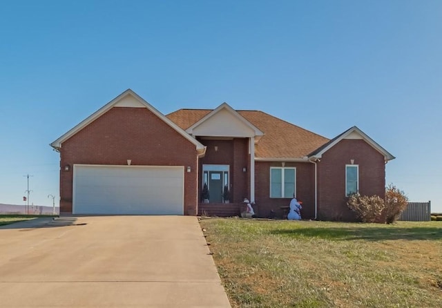 single story home with concrete driveway, a garage, brick siding, and a front yard