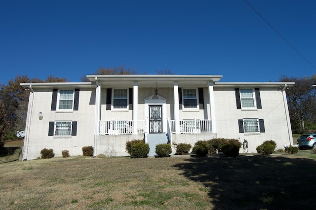 view of front of home featuring covered porch and a front yard