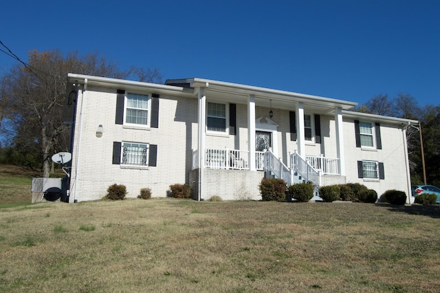 view of front of house with covered porch and a front yard