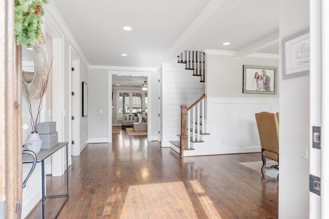 entryway featuring ceiling fan, dark wood-type flooring, and ornamental molding