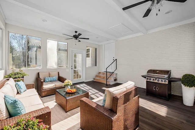 sunroom with beamed ceiling and ceiling fan