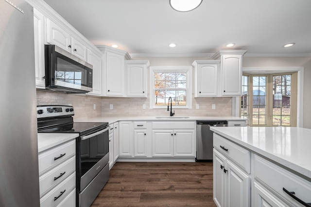 kitchen with white cabinetry, sink, and appliances with stainless steel finishes