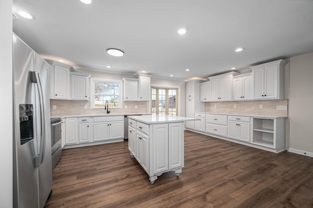 kitchen featuring stainless steel appliances, a center island, dark wood-type flooring, and white cabinets