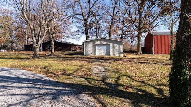 view of yard with a garage and an outdoor structure