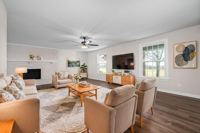 living room featuring a ceiling fan, a fireplace, dark wood-style flooring, and baseboards