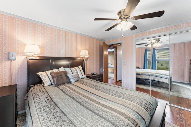 bedroom featuring hardwood / wood-style flooring, a closet, and ceiling fan