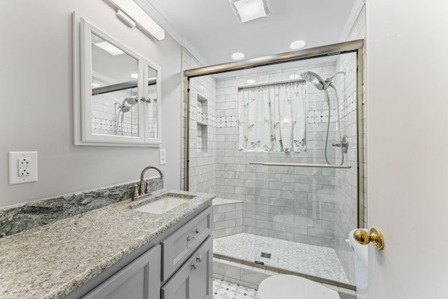 bathroom with vanity, ornamental molding, toilet, and walk in shower