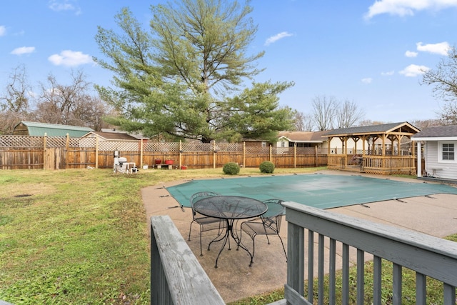 view of swimming pool featuring a yard and a patio area