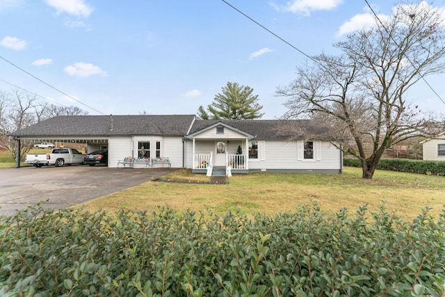 single story home featuring a carport, covered porch, and a front lawn