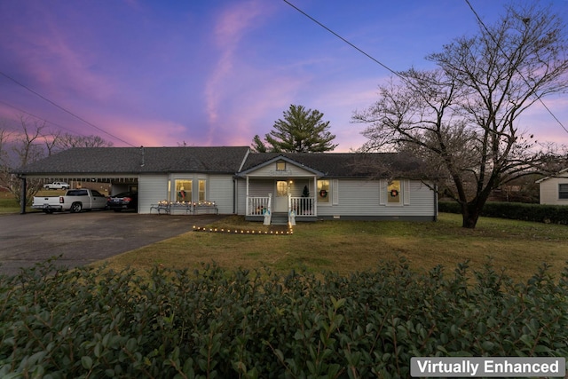 ranch-style house featuring a carport, a porch, and a yard