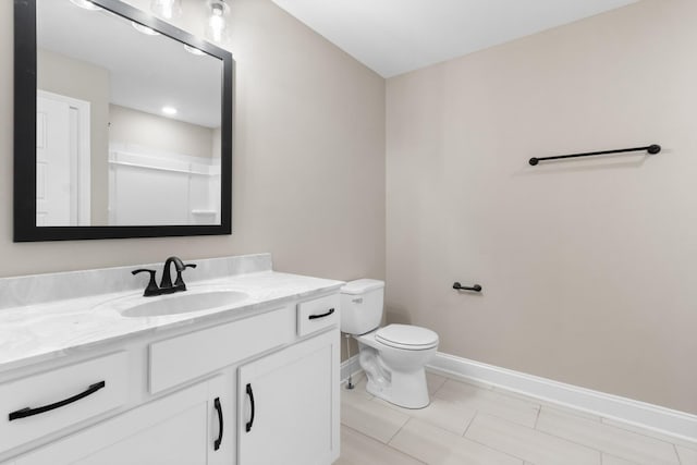 full bath with a shower, toilet, vanity, tile patterned flooring, and baseboards