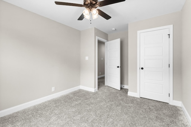 unfurnished bedroom featuring a ceiling fan, baseboards, and carpet flooring