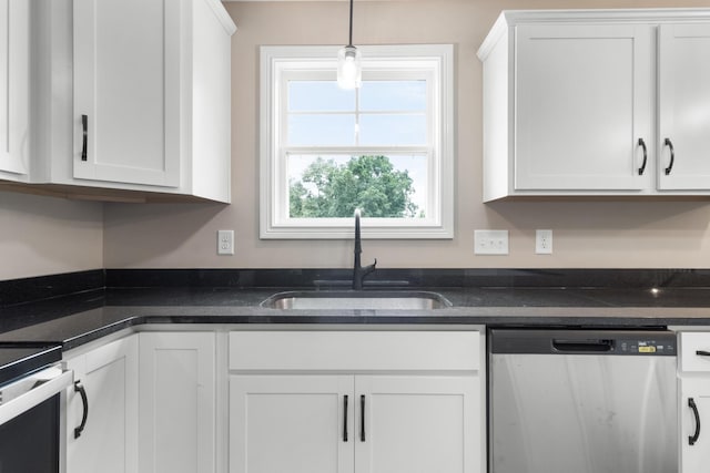 kitchen featuring dishwasher, sink, pendant lighting, and white cabinets