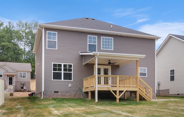 rear view of property with a deck, roof with shingles, stairway, crawl space, and a lawn