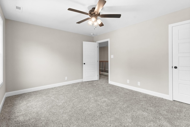 spare room with ceiling fan and carpet flooring