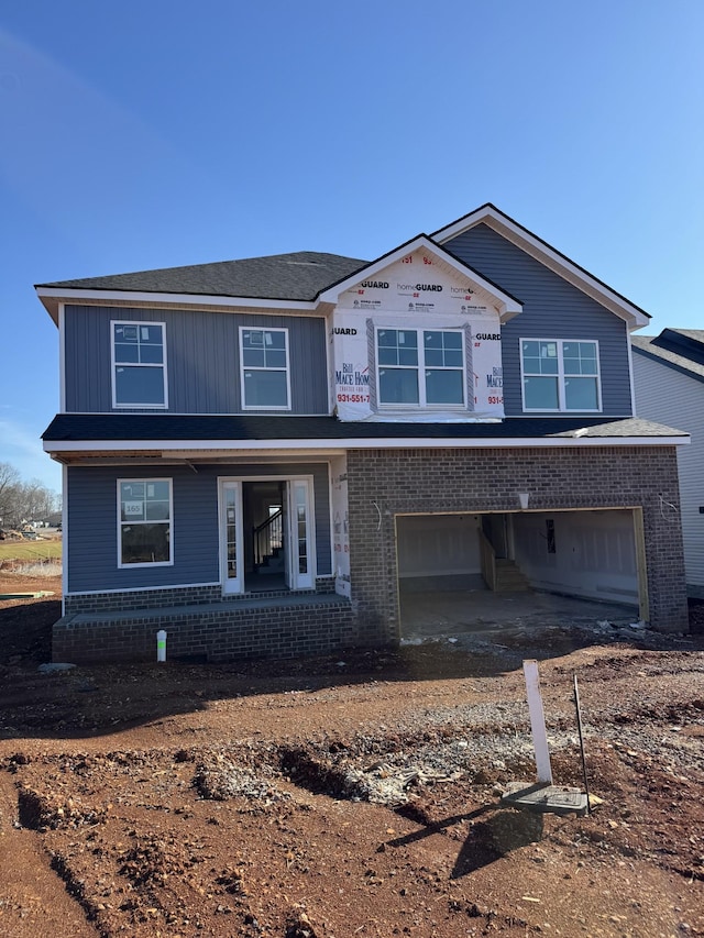 view of front of home featuring brick siding and an attached garage