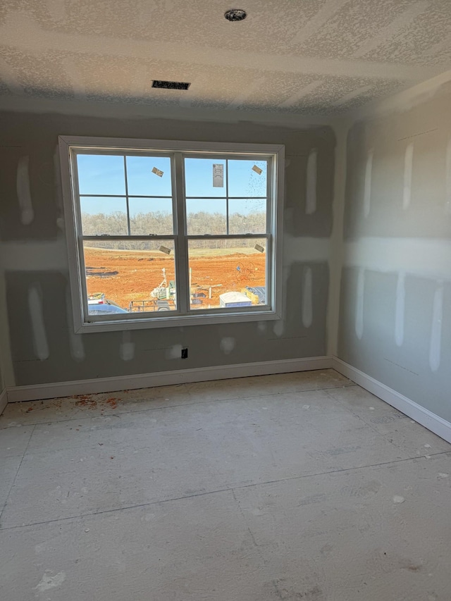 spare room with a healthy amount of sunlight and a textured ceiling