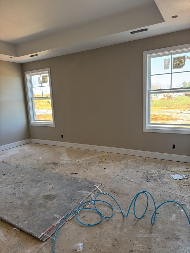 spare room featuring baseboards and visible vents