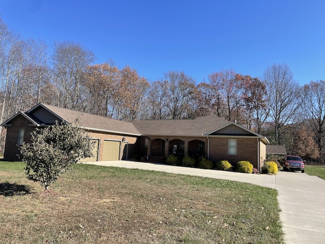 ranch-style house featuring a garage and a front lawn