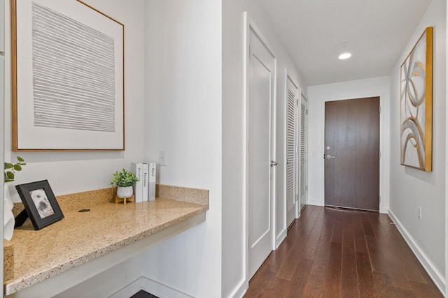 hallway with dark hardwood / wood-style flooring