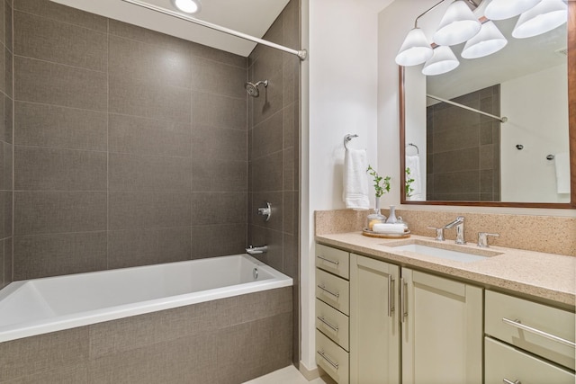 bathroom with vanity and tiled shower / bath combo