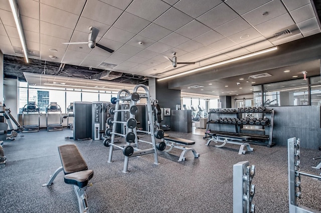 exercise room featuring a paneled ceiling and ceiling fan