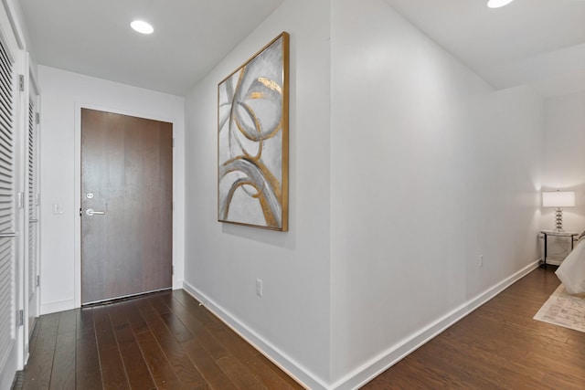 corridor featuring dark wood-type flooring