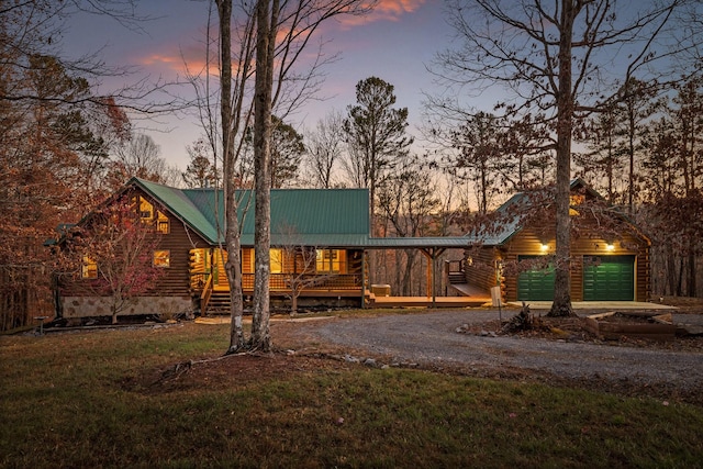 log-style house with a yard and a garage