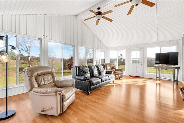 sunroom with vaulted ceiling with beams, a wealth of natural light, and ceiling fan