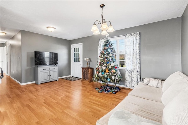 living room featuring hardwood / wood-style floors and an inviting chandelier