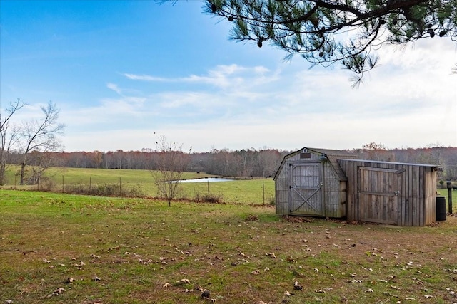 view of yard with a rural view and a storage shed