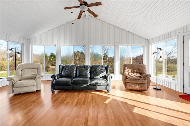 sunroom / solarium with plenty of natural light, lofted ceiling, and ceiling fan