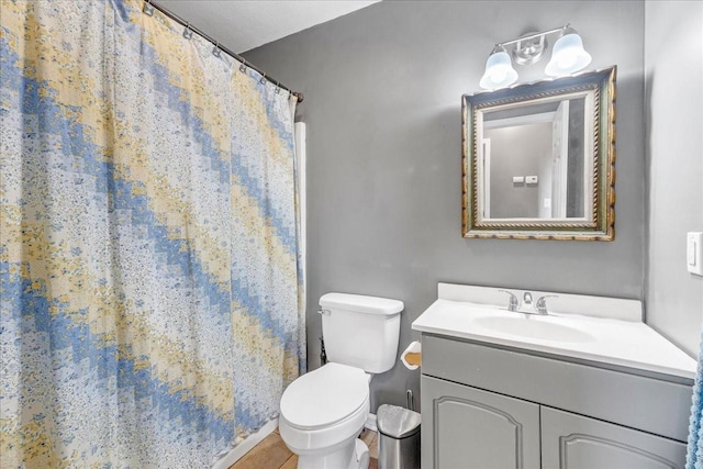 bathroom featuring tile patterned floors, vanity, and toilet