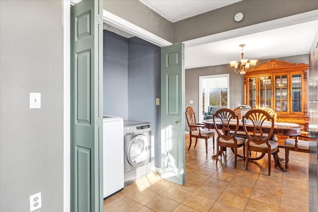 tiled dining room featuring washer and dryer and a chandelier