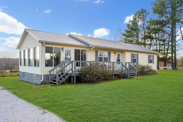 back of house with a lawn and a sunroom