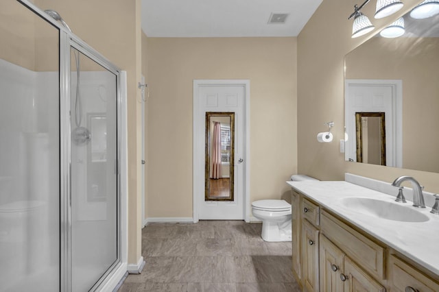 bathroom featuring vanity, toilet, and walk in shower