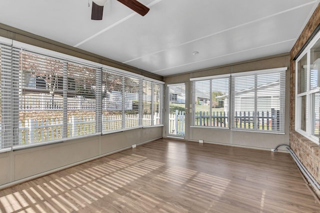 unfurnished sunroom with ceiling fan