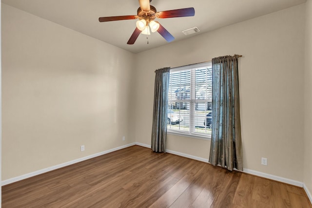 unfurnished room with hardwood / wood-style floors and ceiling fan