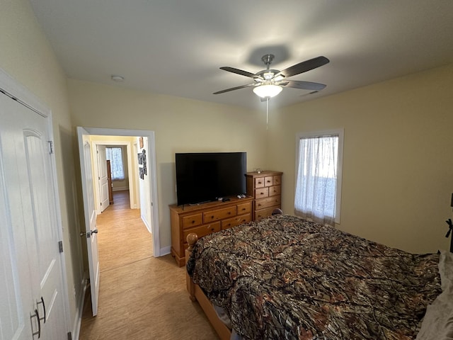 bedroom featuring ceiling fan and light colored carpet