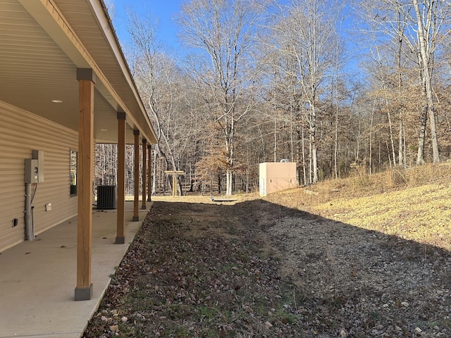 view of yard with central AC unit and a patio area