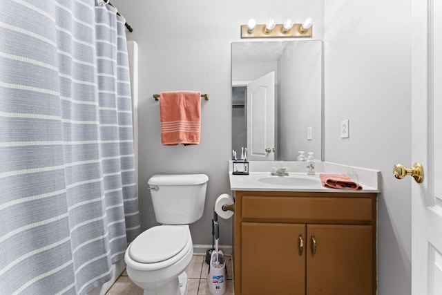 bathroom with tile patterned floors, vanity, and toilet