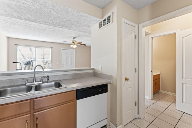 kitchen with a textured ceiling, ceiling fan, sink, light tile patterned floors, and dishwasher