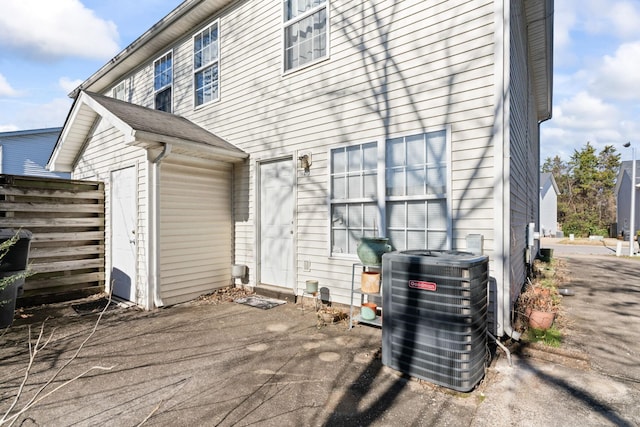 rear view of property featuring central AC