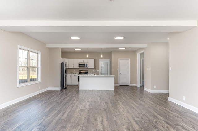 unfurnished living room featuring recessed lighting, baseboards, and wood finished floors