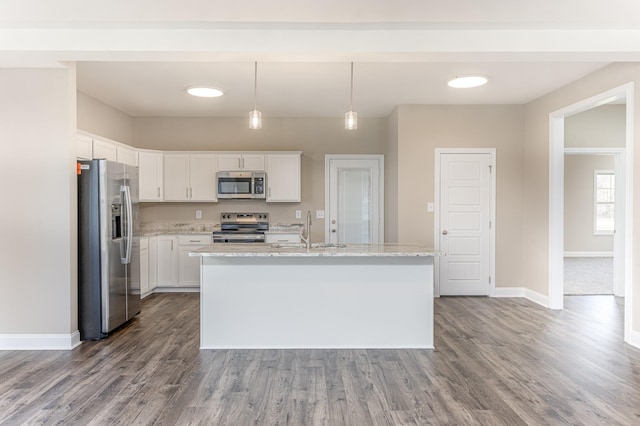 kitchen with a sink, wood finished floors, appliances with stainless steel finishes, and white cabinets