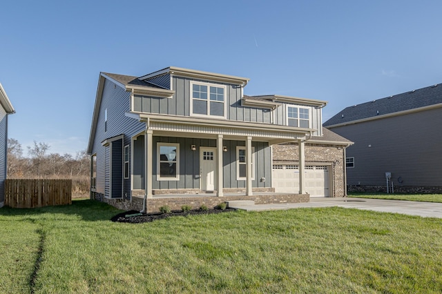 view of front of home featuring a garage, a front lawn, and covered porch